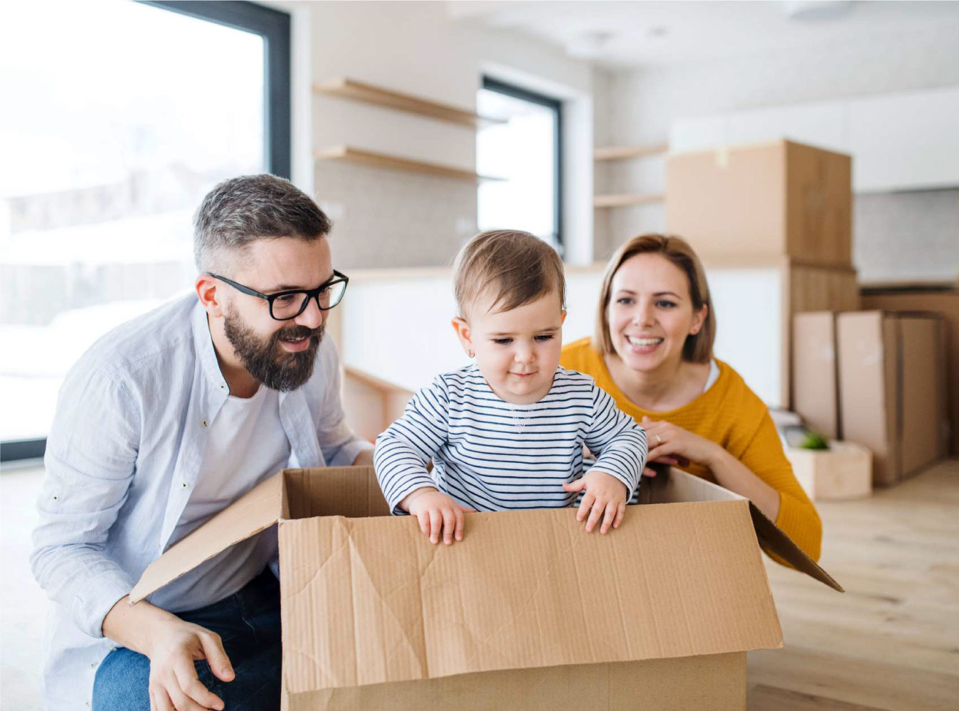 small family with their kid in a moving box
