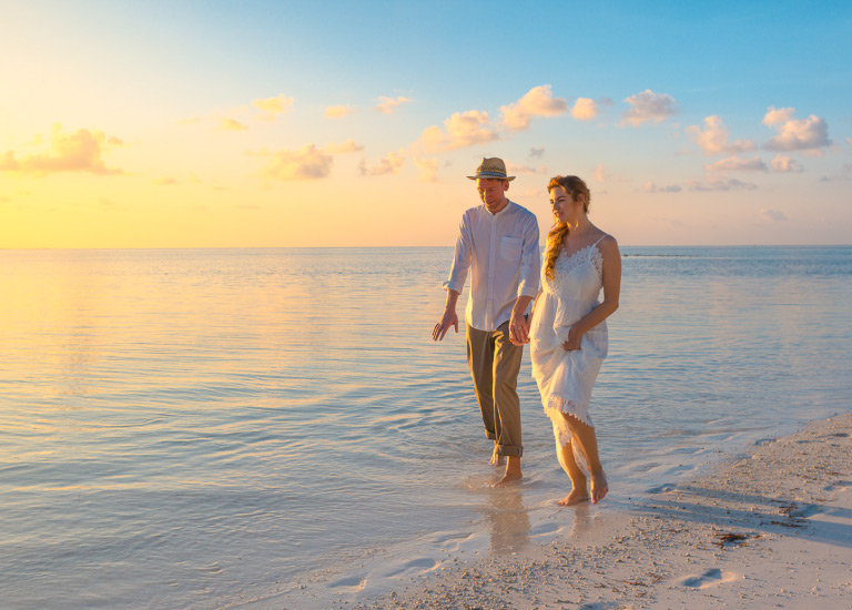 travel insurance couple walking on the beach